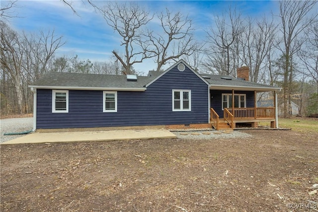 ranch-style home featuring a chimney and a shingled roof