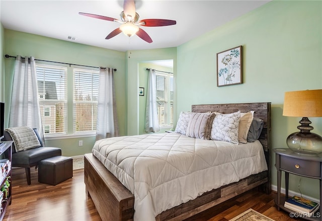 bedroom featuring multiple windows, wood finished floors, and visible vents