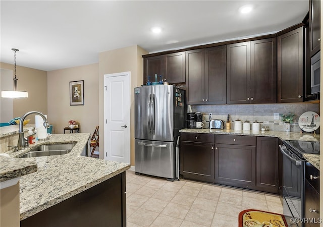 kitchen with freestanding refrigerator, range with electric cooktop, decorative backsplash, a sink, and dark brown cabinets