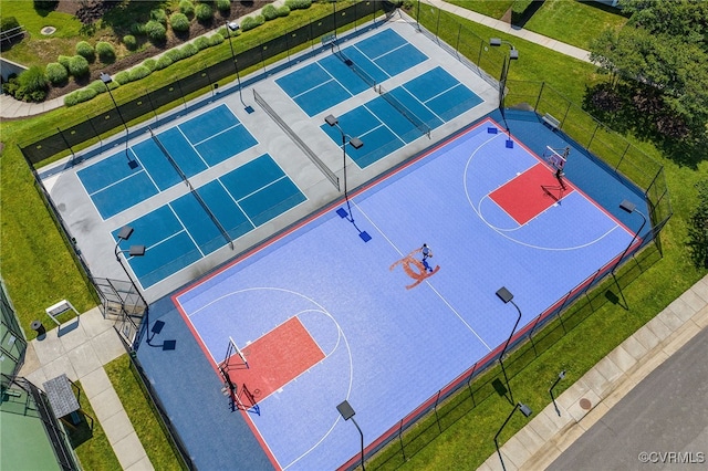 view of sport court with a tennis court, community basketball court, and fence