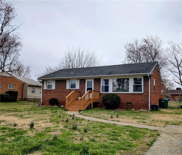 ranch-style home featuring a front lawn, brick siding, and crawl space