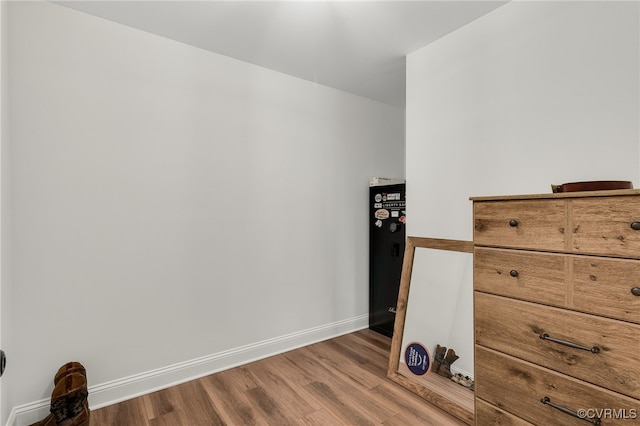 unfurnished bedroom with baseboards and wood finished floors