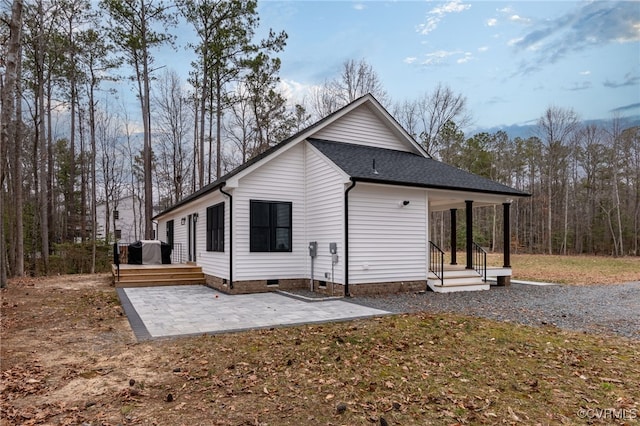 back of house with a patio area, a shingled roof, a wooden deck, and crawl space