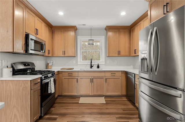 kitchen with a sink, visible vents, light countertops, and stainless steel appliances