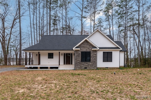 view of front of home with roof with shingles, a porch, crawl space, and a front lawn