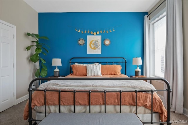 bedroom with carpet flooring, multiple windows, and baseboards