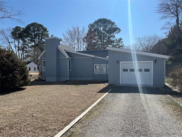 view of property exterior with gravel driveway and a chimney