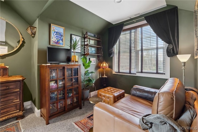 living area with baseboards and carpet floors