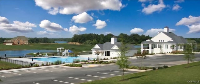 exterior space featuring a water view and a community pool