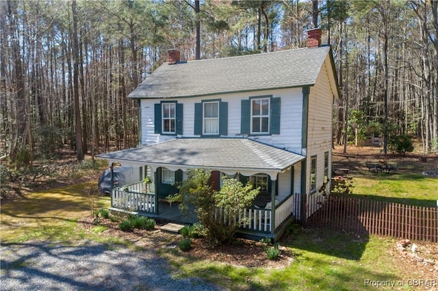 257 Horseshoe Bend Rd, Deltaville, VA 23043 - view of front of house featuring a chimney, covered porch, and roof with shingles