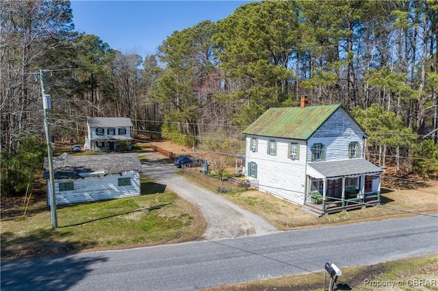 257 Horseshoe Bend Rd, Deltaville, VA 23043 - view of front of house with driveway, a chimney, an outbuilding, and a front lawn