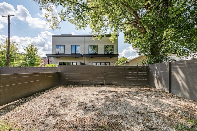 rear view of property with a fenced backyard