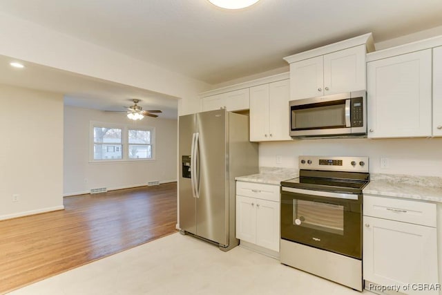 104 Clemwood Pkwy, Hampton, VA 23669 - kitchen with light stone countertops, baseboards, ceiling fan, stainless steel appliances, and white cabinets
