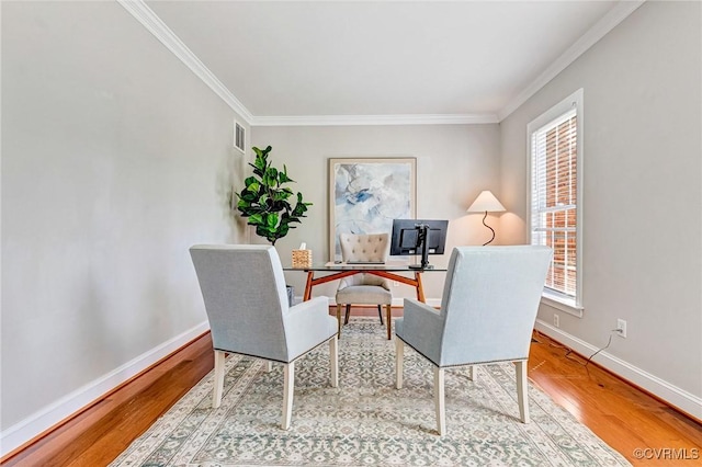 home office with crown molding, baseboards, plenty of natural light, and wood finished floors