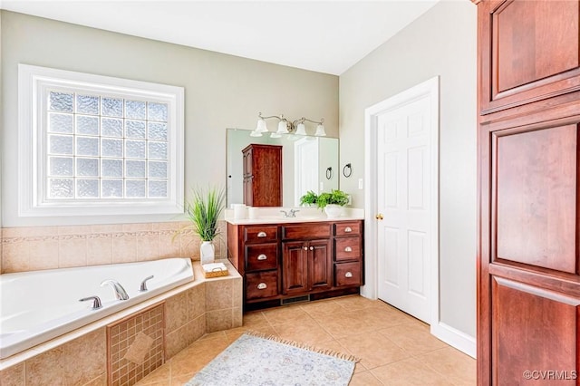 full bathroom with tile patterned flooring, a garden tub, and vanity