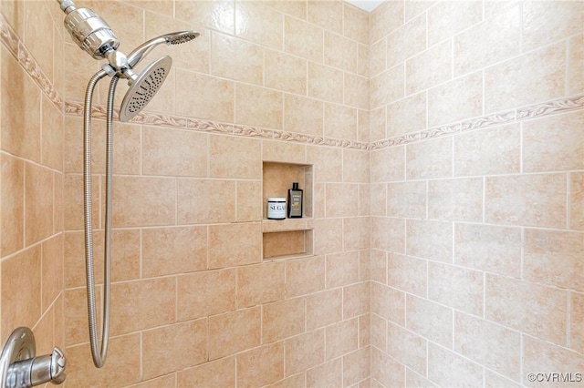 bathroom with tiled shower
