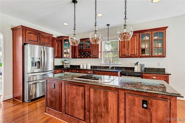 kitchen featuring recessed lighting, a sink, stainless steel fridge with ice dispenser, black electric cooktop, and light wood-type flooring