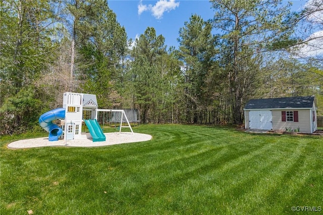 view of yard with a storage shed, a playground, and an outdoor structure