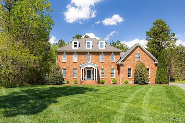 colonial-style house with brick siding and a front lawn