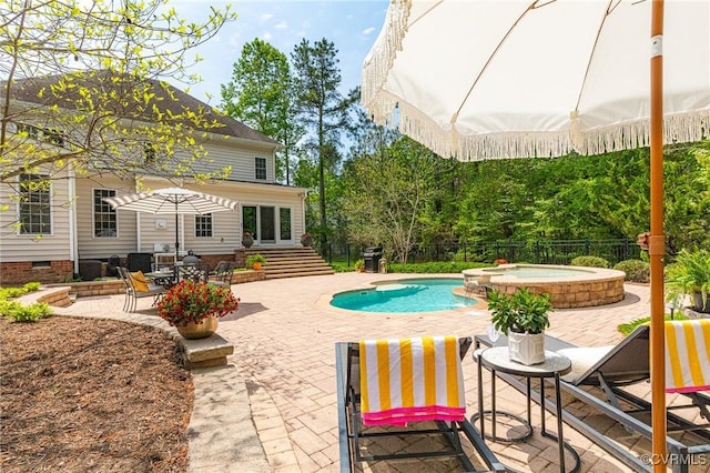 view of pool with a patio area, an in ground hot tub, a fenced in pool, and fence