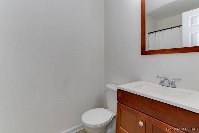 full bath featuring toilet and vanity
