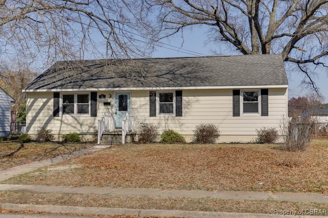 ranch-style house featuring roof with shingles
