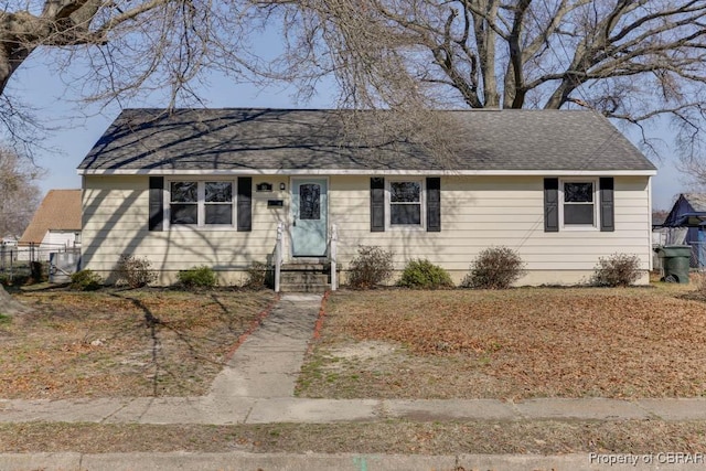 ranch-style house featuring a shingled roof and entry steps