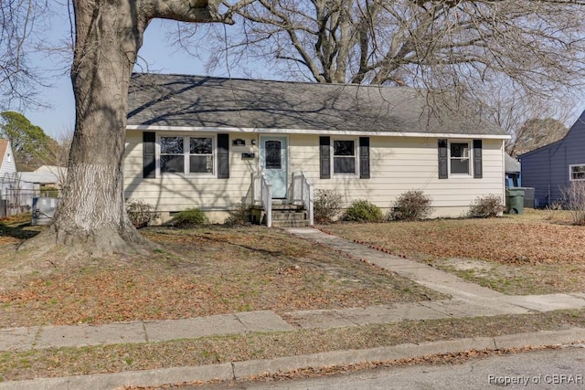 ranch-style house featuring fence, roof with shingles, and crawl space