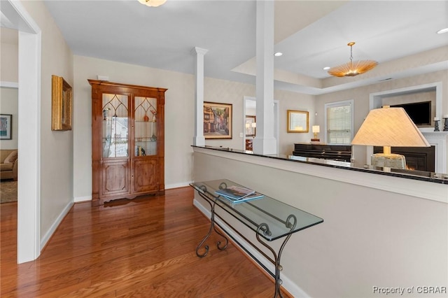 22 Crossroad, Irvington, VA 22480 - interior space with a tray ceiling, wood finished floors, recessed lighting, baseboards, and ornate columns