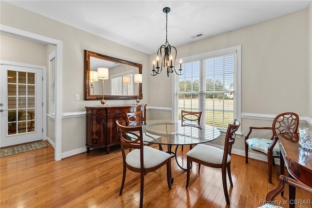 22 Crossroad, Irvington, VA 22480 - dining space with an inviting chandelier, wood finished floors, baseboards, and visible vents