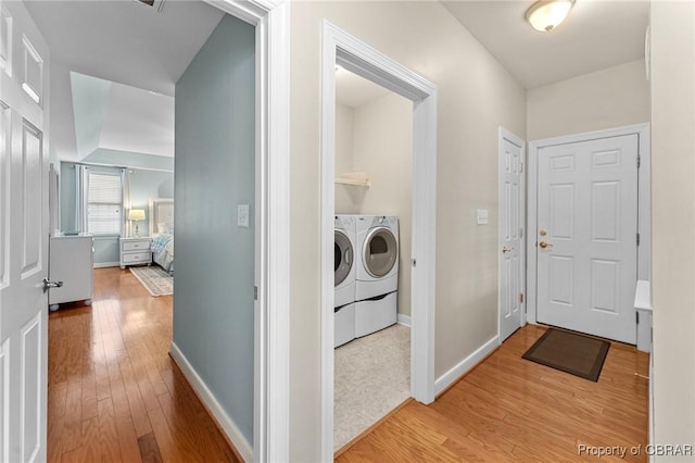 22 Crossroad, Irvington, VA 22480 - clothes washing area featuring washing machine and clothes dryer, laundry area, light wood finished floors, and baseboards