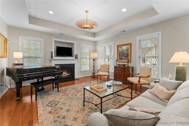 22 Crossroad, Irvington, VA 22480 - living room with a fireplace with flush hearth, a healthy amount of sunlight, baseboards, and a tray ceiling