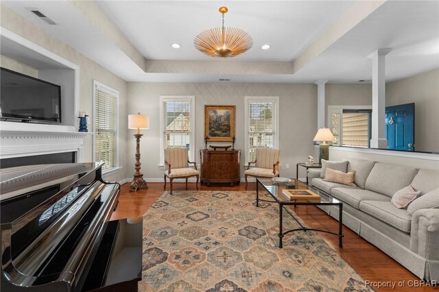 22 Crossroad, Irvington, VA 22480 - living area with wood finished floors, visible vents, ornate columns, baseboards, and a tray ceiling