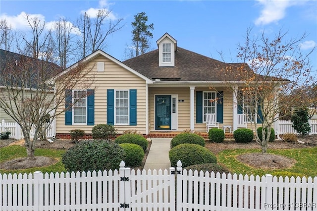 22 Crossroad, Irvington, VA 22480 - view of front of property with a fenced front yard, covered porch, a shingled roof, and a gate