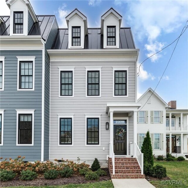 townhome / multi-family property with metal roof