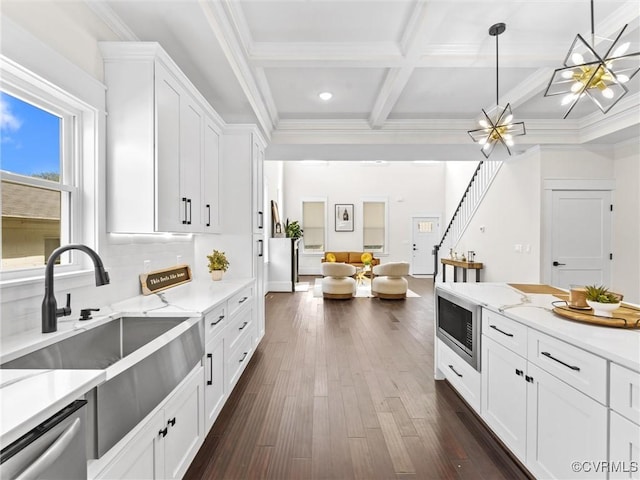 kitchen featuring open floor plan, white cabinets, coffered ceiling, stainless steel appliances, and a sink