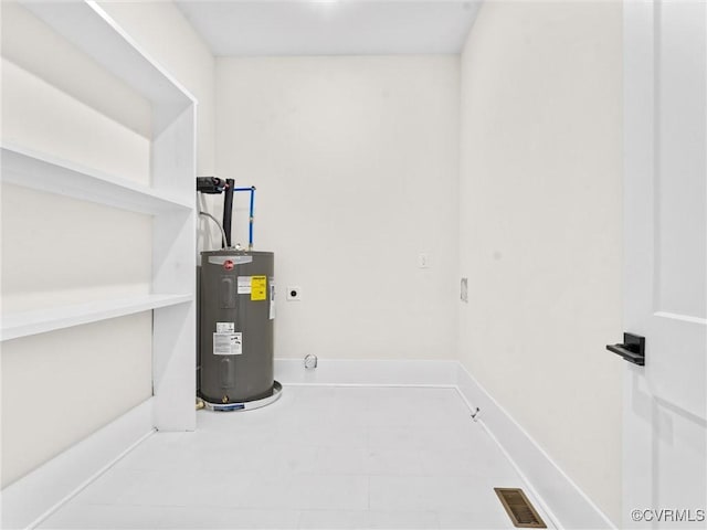 utility room featuring water heater and visible vents