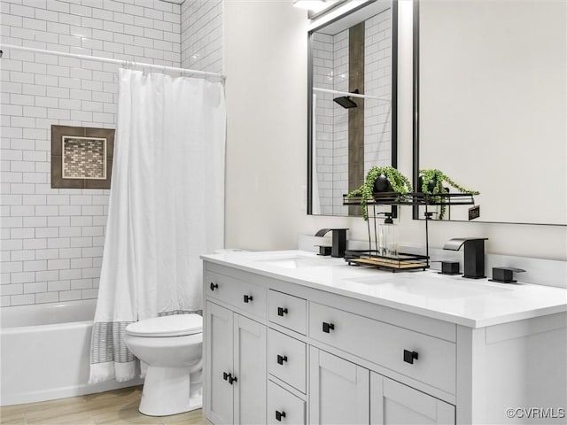bathroom with toilet, shower / tub combo with curtain, vanity, and wood finished floors