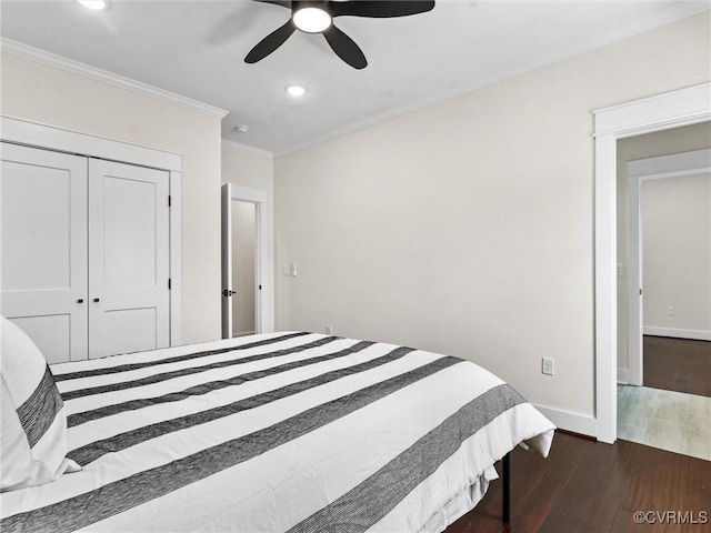 bedroom with recessed lighting, dark wood-style floors, a closet, and ornamental molding