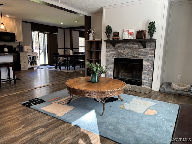 16690 Shands Rd, South Prince George, VA 23805 - living area with a fireplace, dark wood-style flooring, and a textured ceiling