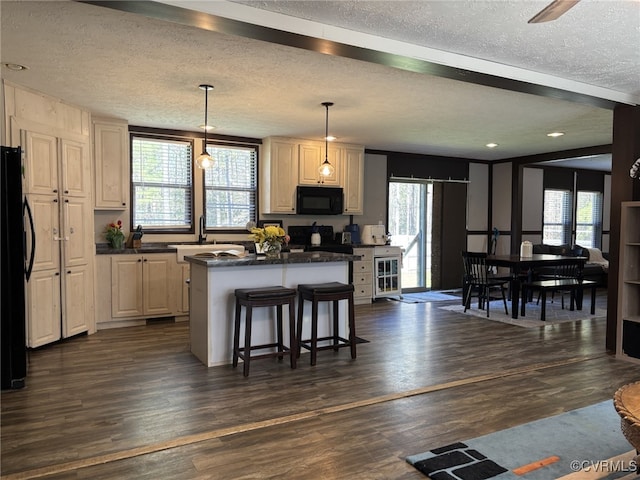 16690 Shands Rd, South Prince George, VA 23805 - kitchen featuring dark countertops, black appliances, dark wood-style floors, and a center island