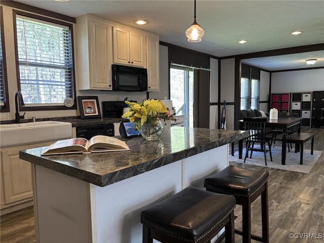 16690 Shands Rd, South Prince George, VA 23805 - kitchen with dark countertops, dark wood finished floors, a kitchen bar, recessed lighting, and black appliances