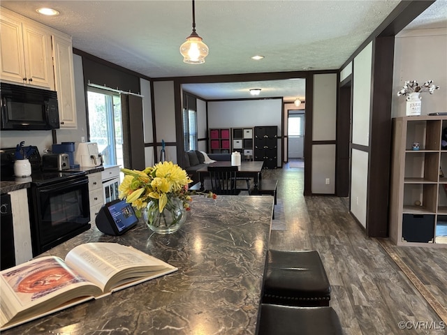 16690 Shands Rd, South Prince George, VA 23805 - kitchen with dark wood-style flooring, ornamental molding, black appliances, a textured ceiling, and dark countertops