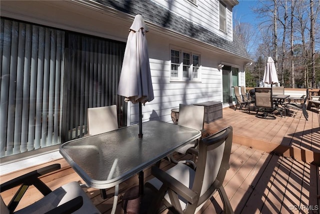 wooden terrace featuring outdoor dining space