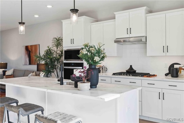 15313 Sunray Way, Chesterfield, VA 23832 - kitchen featuring under cabinet range hood, stainless steel appliances, backsplash, white cabinetry, and a breakfast bar area