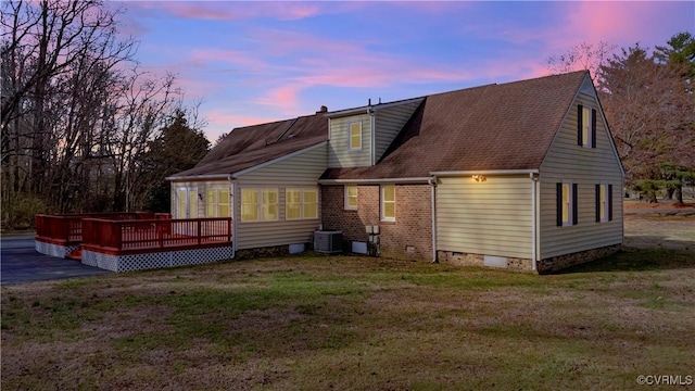 back of house featuring a wooden deck, central AC, a shingled roof, crawl space, and a lawn