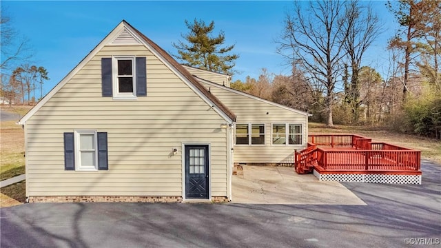 rear view of property with a patio area and a deck