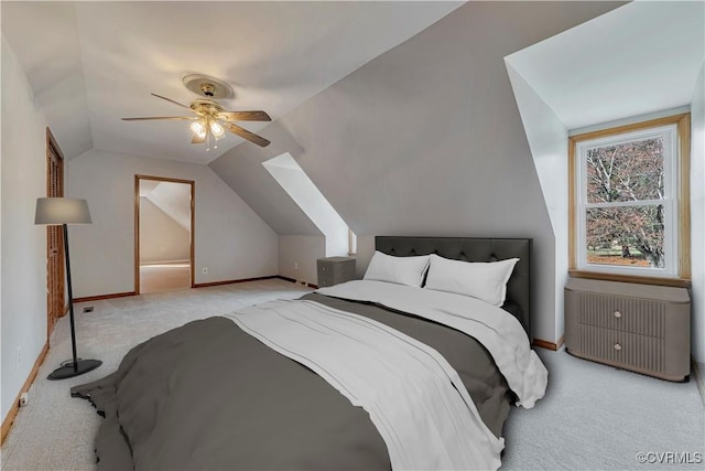 carpeted bedroom featuring lofted ceiling, radiator, baseboards, and ceiling fan