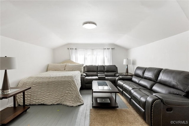 bedroom with hardwood / wood-style flooring and vaulted ceiling