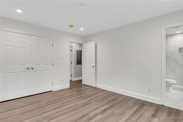 42 Mt Elba Rd, Columbia, VA 23038 - unfurnished bedroom with electric panel, recessed lighting, baseboards, a closet, and light wood finished floors